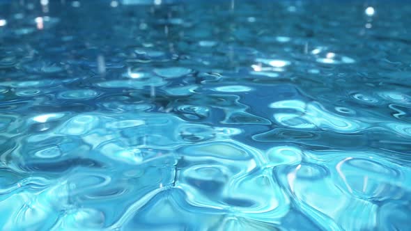 Pure Blue Water in the Pool with Light Reflections