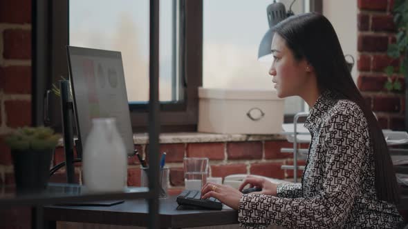 Business Woman Celebrating Project Achievement at Desk