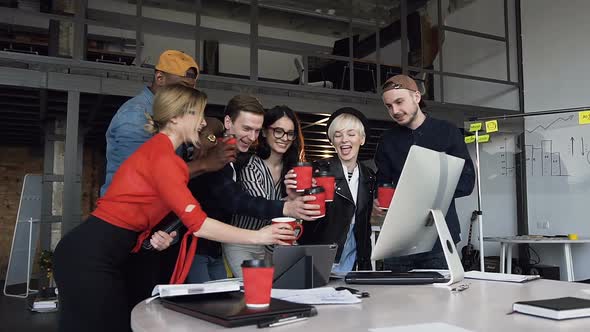 Team of Hipster Office Worker Clinking a Cup of Tea