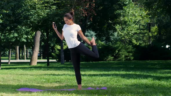 Girl Makes a Selfie Doing Yoga in Park