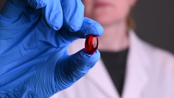 Female Holds Out a Red Pill During a Coronavirus Epidemic. Treatment of People