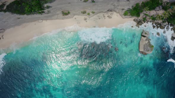 Aerial View of Drone Moves Away From Mesmerizing Landscape with Turquoise Waves