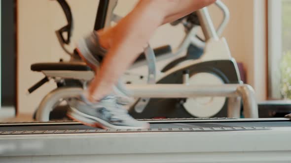 Man Legs Treadmill Running In Home. Cardio Run Workout. Sportsman Jogging Treadmill Running.