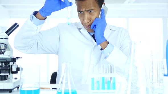 Scientist Talking on Phone in Laboratory