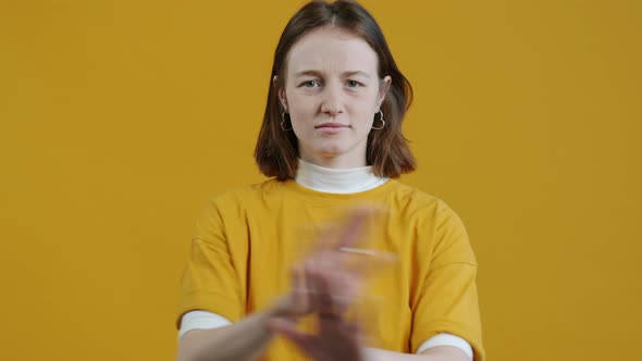 Portrait of Young Woman Crossing Arms and Shaking Head Forbidding