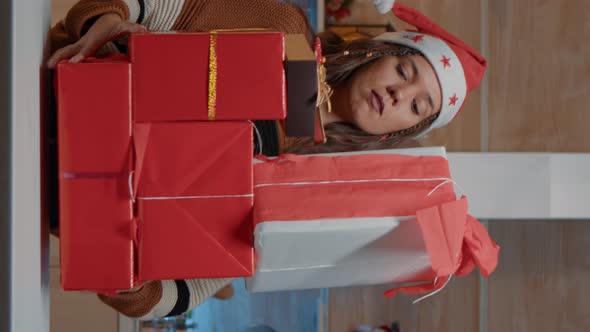 Vertical Video Festive Woman Putting Presents on Kitchen Counter