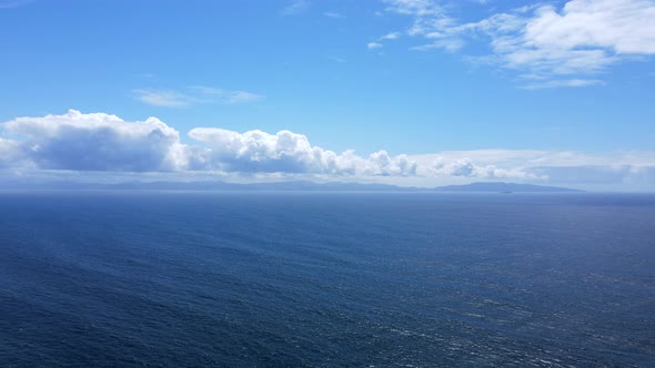 4k aerial still footage showing pacific ocean with blue cloudy sky on an early summer day on Vancouv