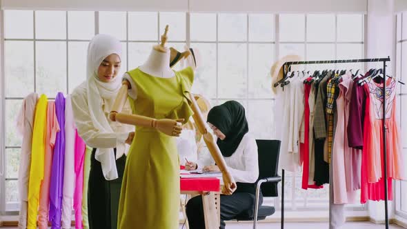 Muslim women fashion designers are in process of creating new clothes collection.