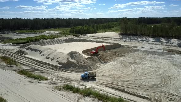 Car with Freight Drives Out of Sandpit in Summer Upper View