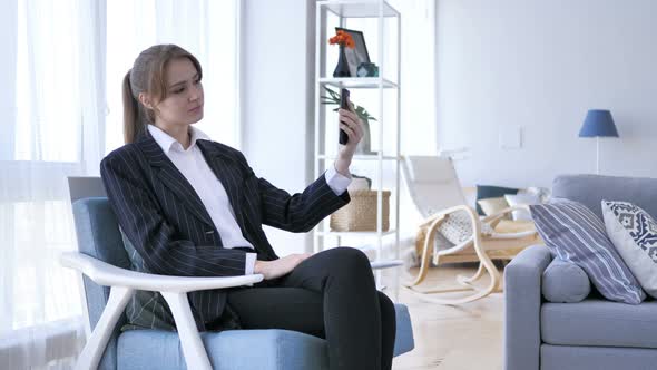 Woman in Office Taking Selfie on Smartphone