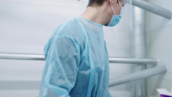 Nurse In Handing Phone To Doctor