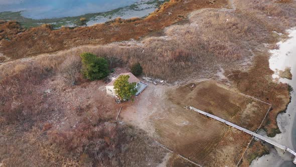 A top down drone shot over the marsh in Freeport, NY during the evening. The camera dolly in & tilt