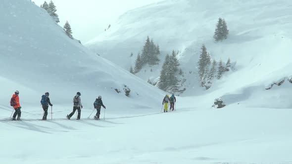 Group of children doing ski touring with a guide instructor. Ski touring in the mountains
