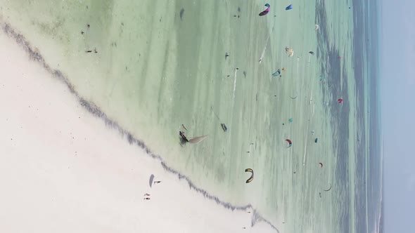 Vertical Video Kitesurfing Near the Shore of Zanzibar Tanzania Aerial View