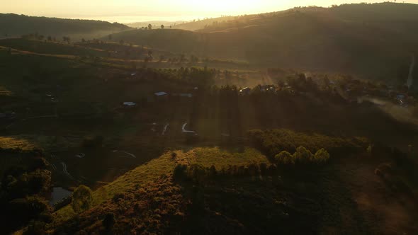 4K Morning mist over a rural village in the high mountains.