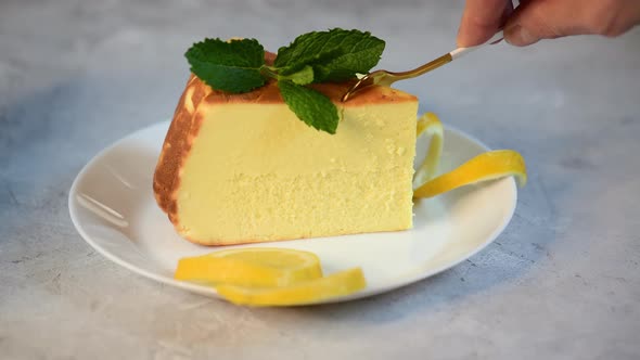 delicious cheesecake with lemon on plate with spoon