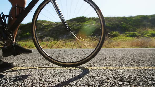 Triathlete man cycling in the countryside road