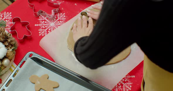 Cutting Out Gingerbread Cookies From Dough in Kitchen, Medium.