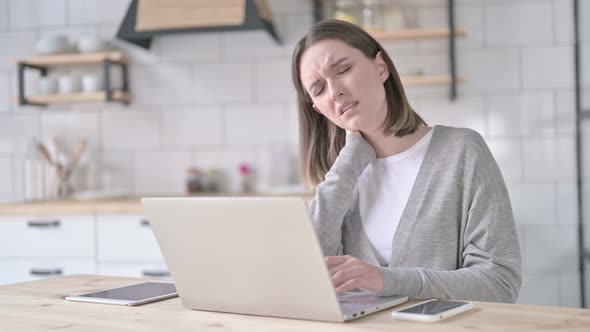 Tired Young Woman Having Neck Pain in Office