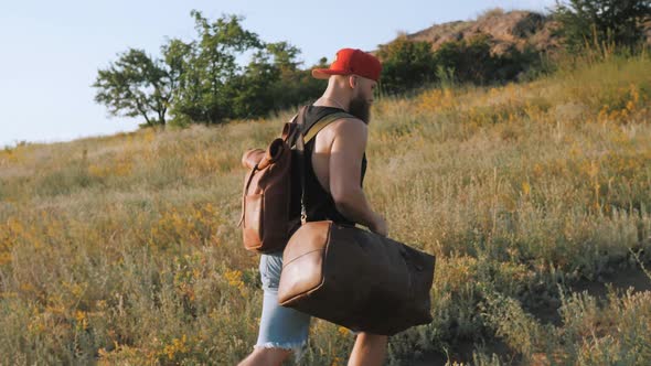 Brutal male tourist walking through the wild, on mountains