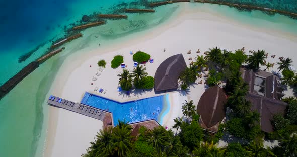 Wide angle birds eye tourism shot of a white sand paradise beach and turquoise sea background in vib