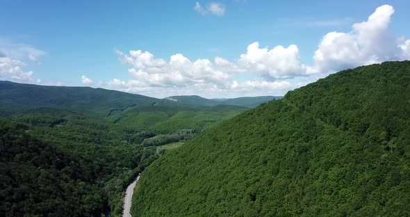 Aerial View of a Rural Highway Between Mountains