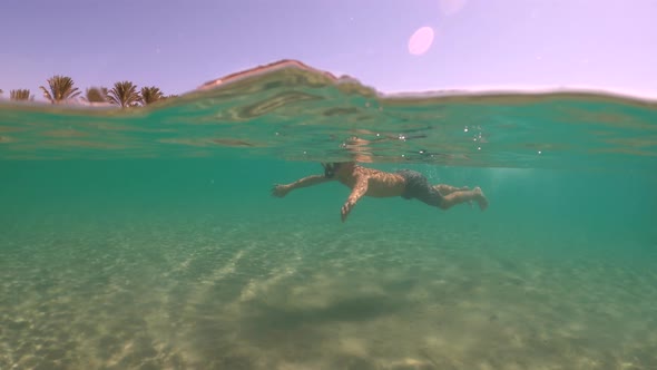Boy Snorkeling Near the Sandy Beach in Egypt. Red Sea. Vacation at Sea.