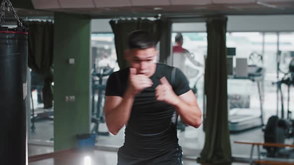 Young Man Performing Shadow Boxing in the Gym