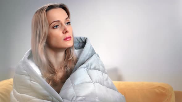 Upset Woman Warming in Blanket Thinking Worried About Problem