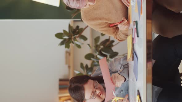 Man with Down Syndrome and Social Worker Doing Paper Crafts