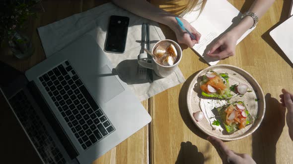 Female Student Writes Course Work on Her Computer Freelancer Girl Working at Cafe Via Notebook