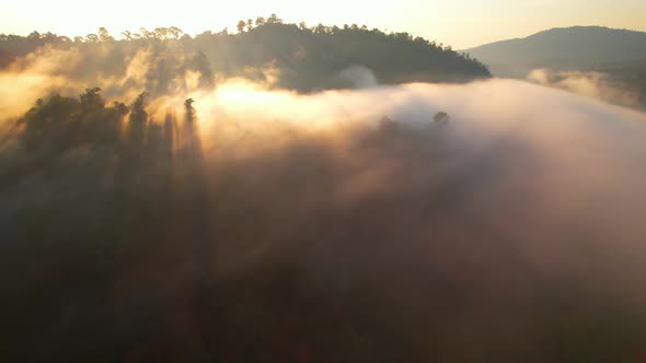 4K Flying through the clouds above mountain tops