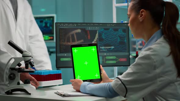 Scientist Holding Tablet with Green Chroma Key Screen