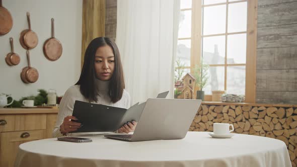 Young Adult Businesswoman Discussing Her Report on a Video Conference Call From Her Apartment