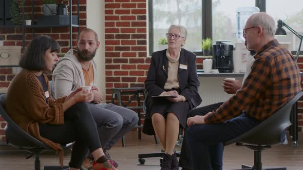 People with Mental Health Issues Attending Aa Support Group Session with Therapist