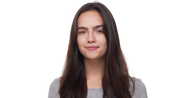 in Slow Motion Portrait of Confident Young Woman with Long Dark Hair Opening Eyes and Looking at