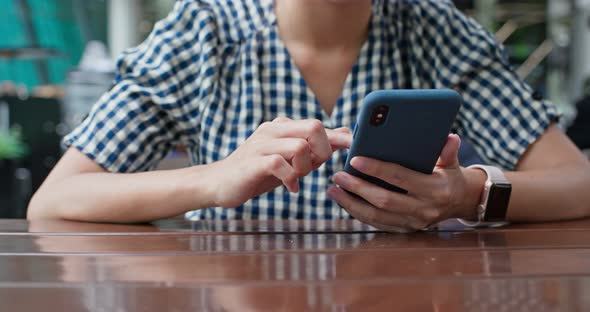 Woman use of mobile phone in restaurant