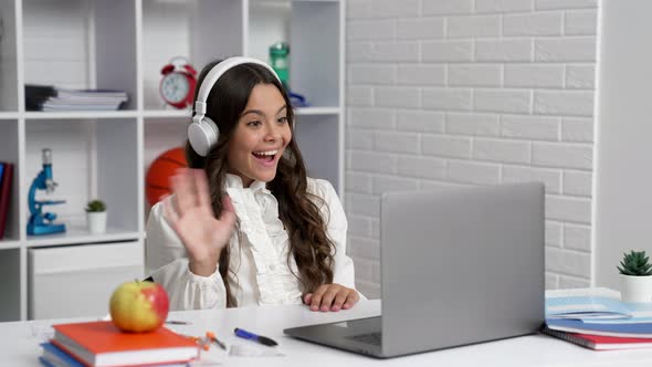 Happy Kid in Headphones Study at School Online Lesson with Computer Saying Hello Video Call