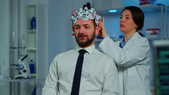 Neurologist Doctor Analysing Brain of Man Using Brainwave Scanning Headset