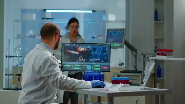 Medical Scientist Working with DNA Scan Image