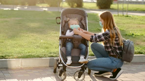 Woman Disinfecting Her Daughter's Hands Outdoors