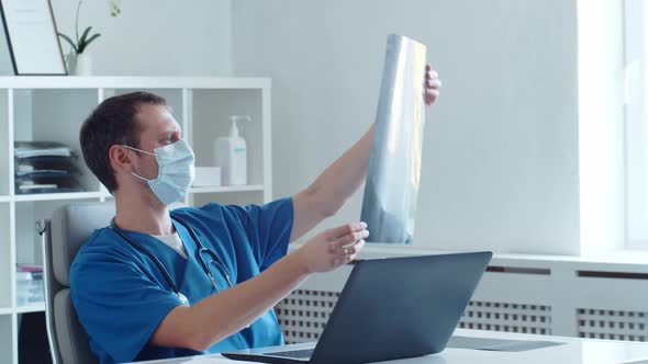 Professional medical doctor working in hospital office using computer technology.