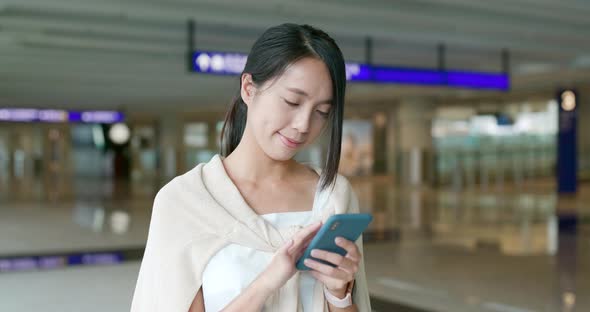 Woman use of mobile phone in the airport