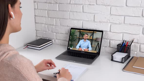 Woman study at home office online conference video call laptop tells teacher