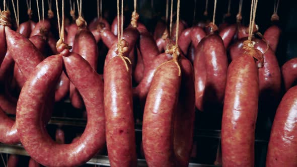 Many Wieners Are Preparing on a Rack at Meat Packing Factory.