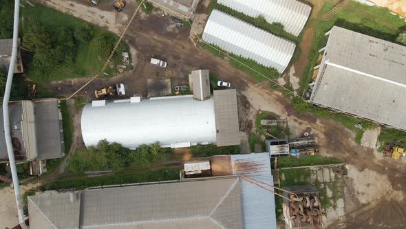 Aerial View of Wood Processing Factory with Smoke From Production Process Polluting Atmosphere at