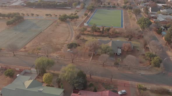 AERIAL shot over a school and hockey field in south africa during winter
