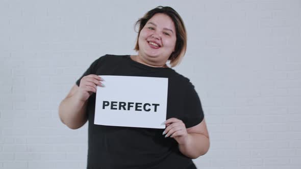 Concept Body Positivity an Overweight Smiling Woman Dancing and Holds a Sign with the Inscription