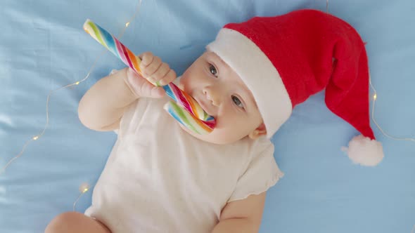 Portrait of Adorable Infant Baby Girl Wearing Santa Hat. Christmas Celebration Concept