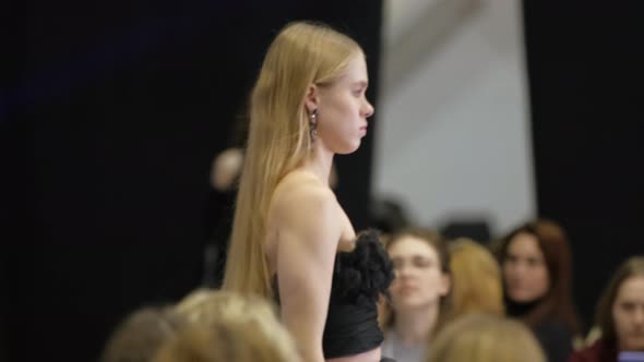 Female Fashion Model with Light Colored Blonde Hair on Catwalk Podium Runway